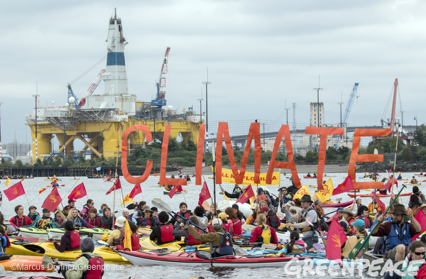 Kayaks participate in the sHell No Flotilla part of the Paddle In Seattle