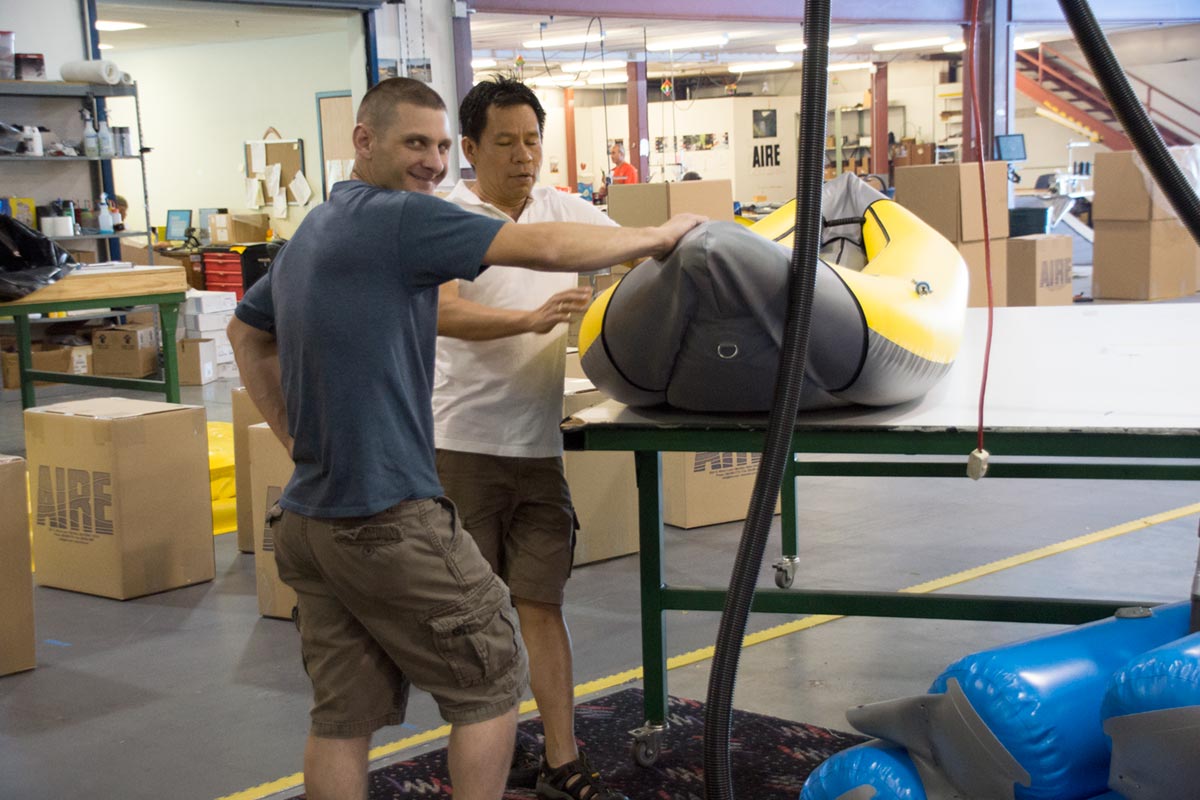 AIRE Craftspersons Inspect and Discuss Nearly Finished Inflatable Kayak